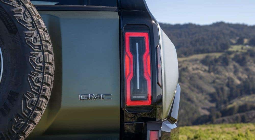 Close-up on the taillight of a grey 2025 GMC Hummer EV SUV.