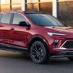 A red 2025 Buick Encore GX ST is shown parked on a driveway.