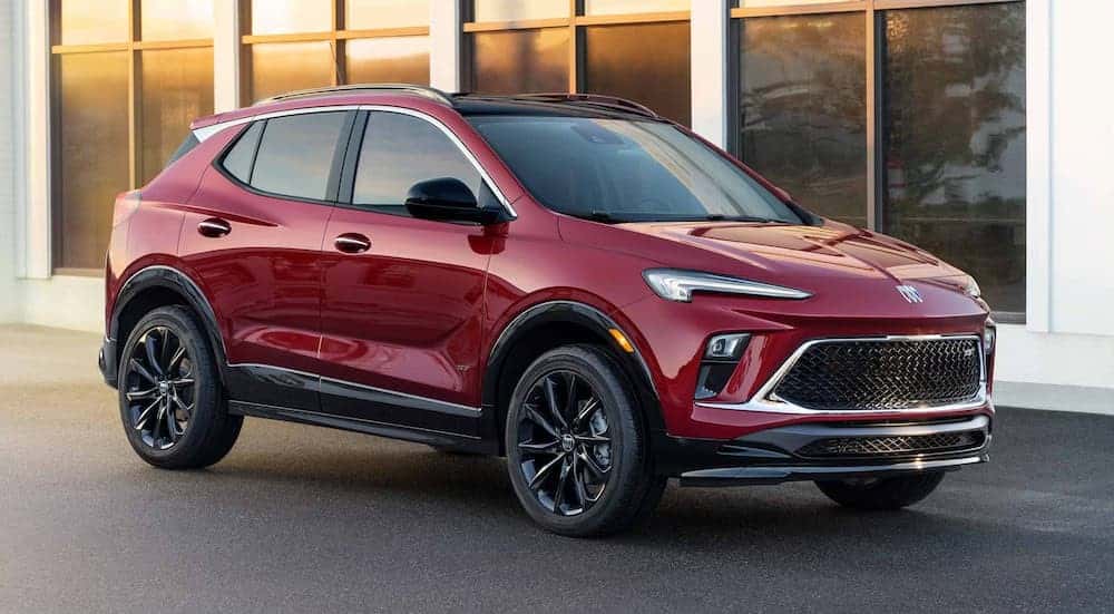 A red 2025 Buick Encore GX ST is shown parked on a driveway.