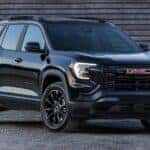 A black 2025 GMC Terrain parked off-road and angled right after visiting a GMC dealer near Alpharetta.