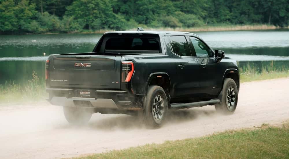 Black 2026 GMC Sierra EV AT4 driving to a GMC dealer near Alpharetta