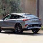 A grey 2025 Buick Envista is shown parked near a tree.