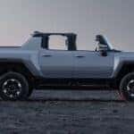 A gray 2025 GMC Hummer EV Pickup parked off-road.