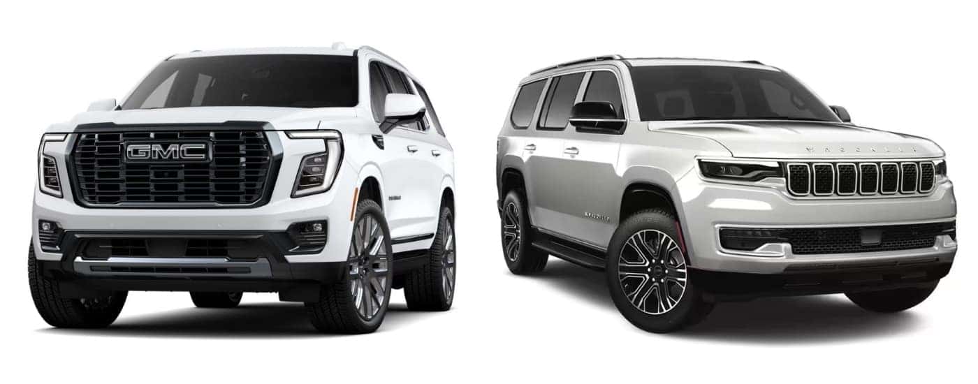 A white 2025 GMC Yukon Denali Ultimate angled left and a white 2025 Jeep Wagoneer angled right.