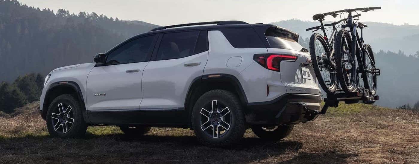 A white 2026 GMC Terrain AT4 parked off-road.