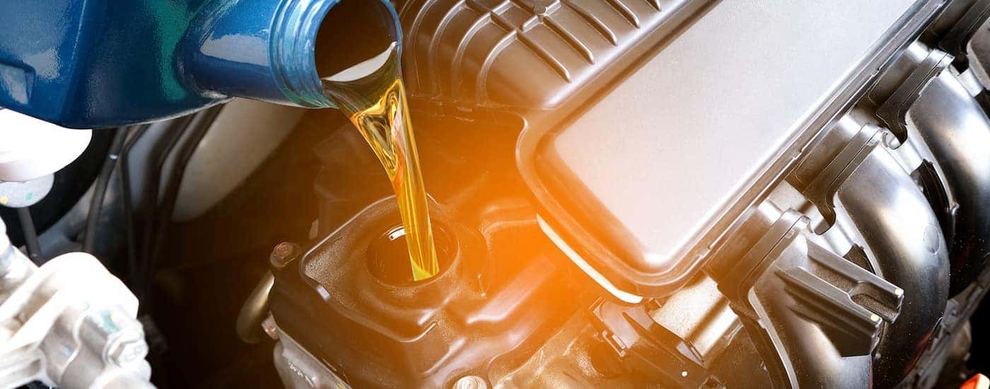 A close-up of oil being poured into an engine
