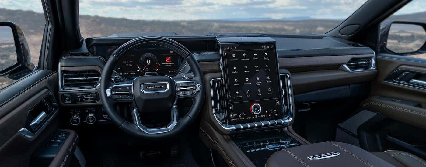 Black steering wheel and dashboard inside a 2025 GMC Yukon XL.