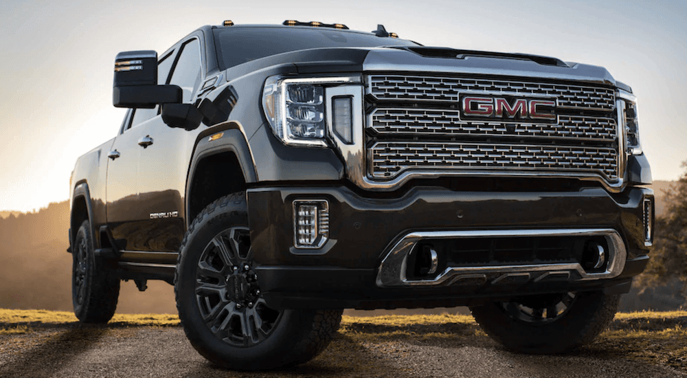 Black 2025 GMC Sierra 3500 HD Denali parked on a trail.