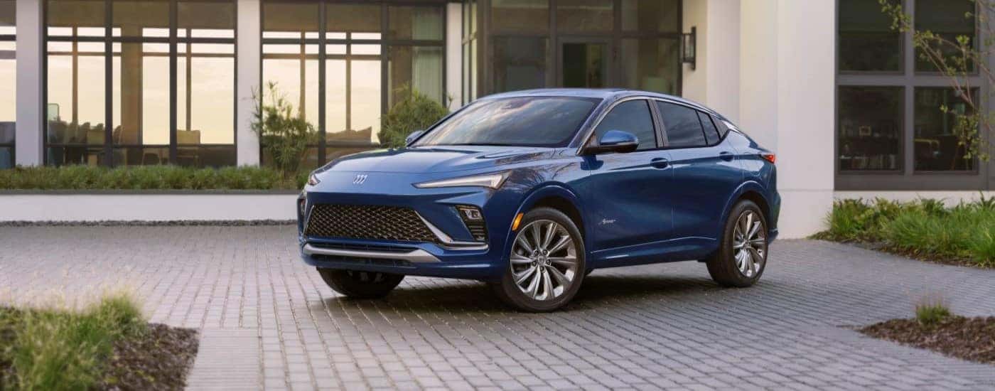 A blue 2024 Buick Envista Avenir is shown parked on a driveway after visiting a Buick dealer near Carrollton.
