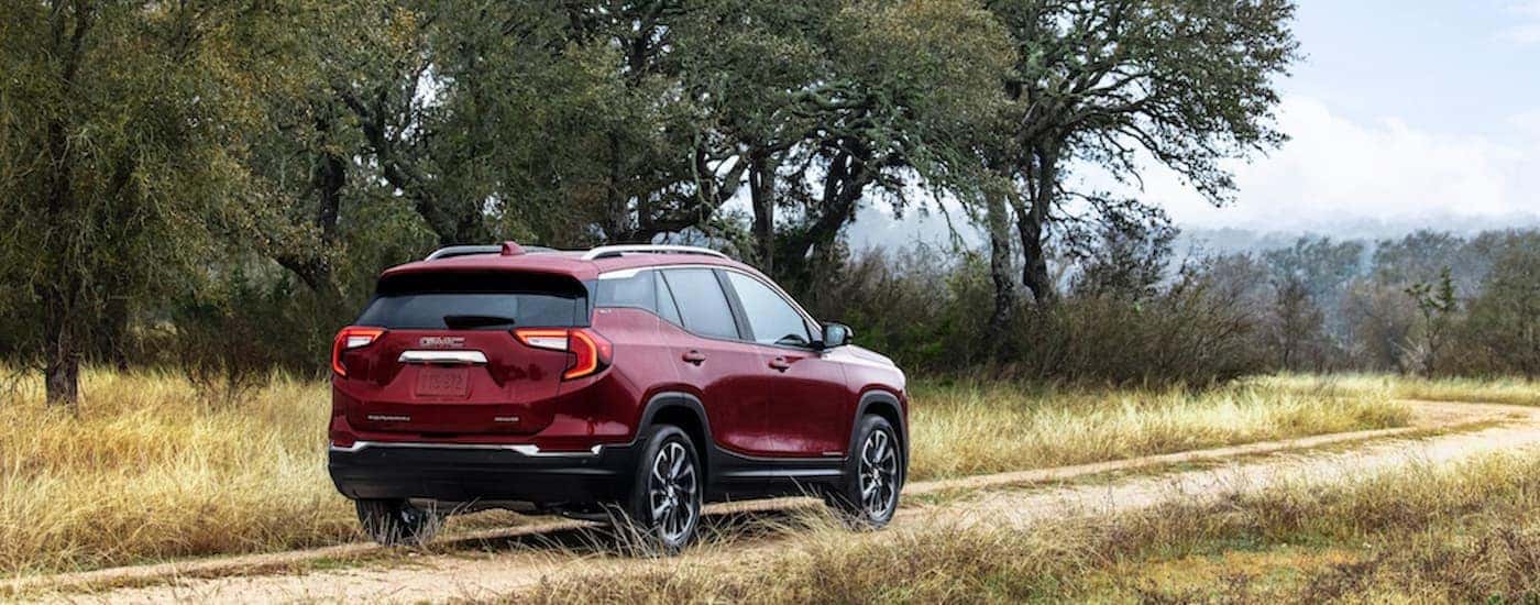 A red used 2022 GMC Terrain parked on a dirt trail