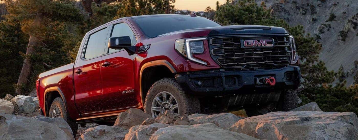 Red 2026 GMC Sierra 1500 AT4X parked off-road