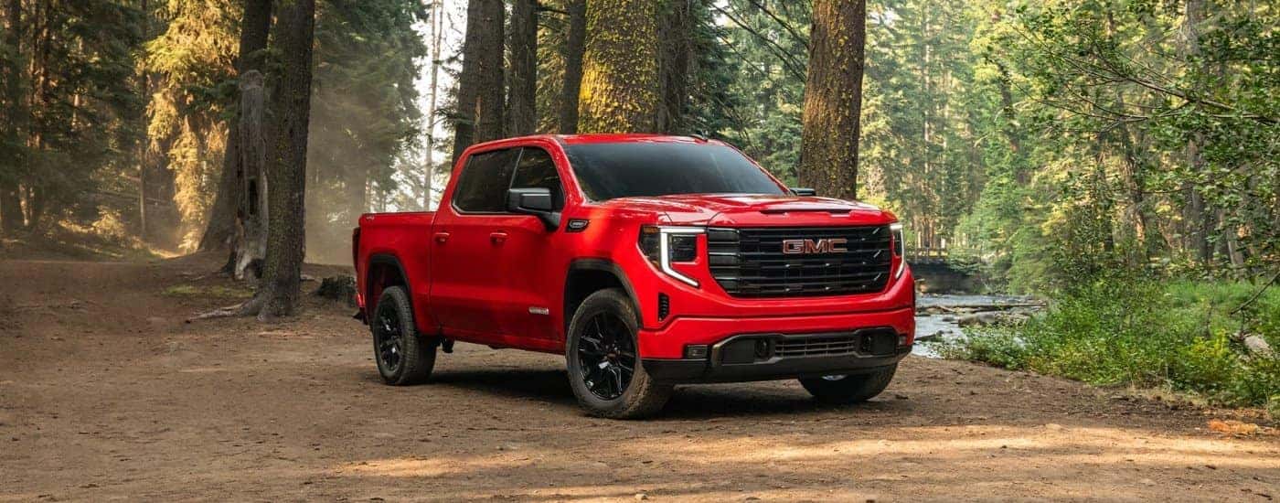 Red 2026 GMC Sierra 1500 Elevation parked near a river