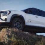White GMC Terrain AT4 for sale near Marietta parked high on a hill.
