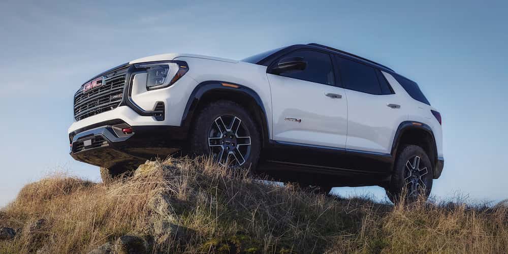 White 2026 GMC Terrain AT4 for sale near Marietta parked high on a hill.
