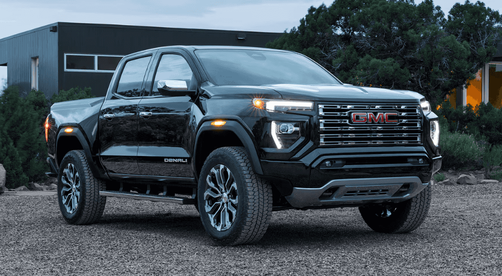 Black 2026 GMC Canyon parked in front of a home