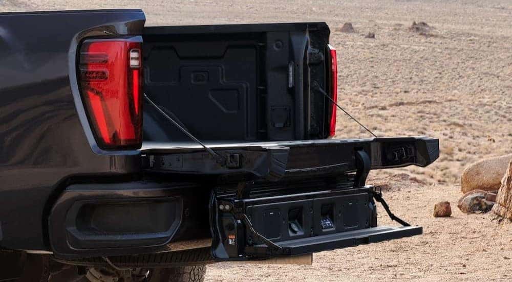 The open tailgate on a black 2026 GMC Sierra 2500 HD.