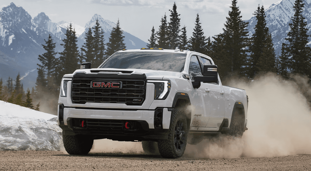 White 2026 GMC Sierra HD AT4 driving off road
