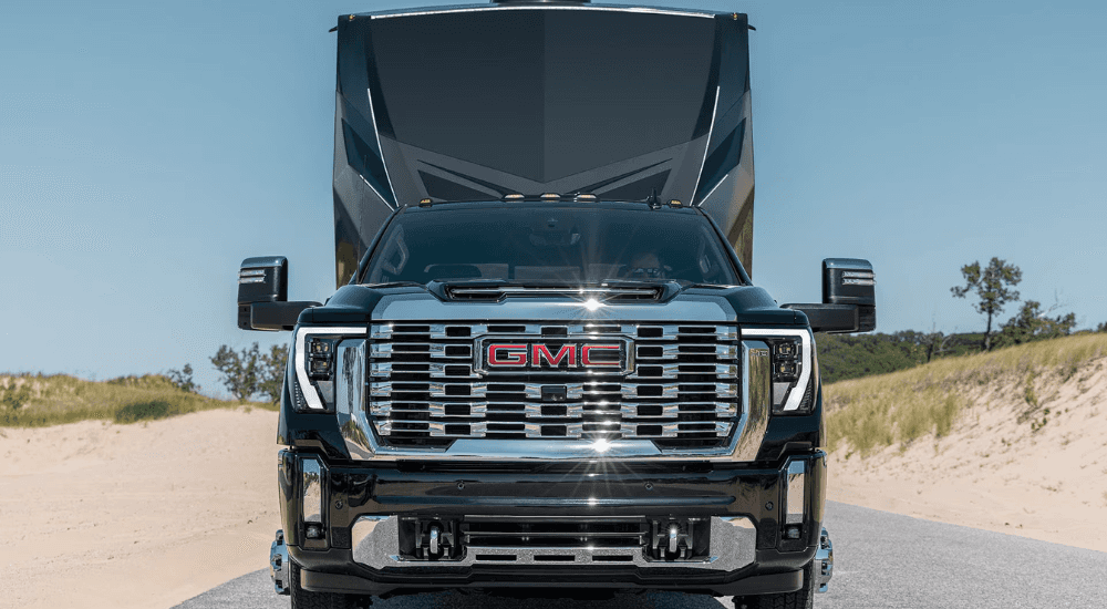 Black 2026 GMC Sierra HD towing an RV