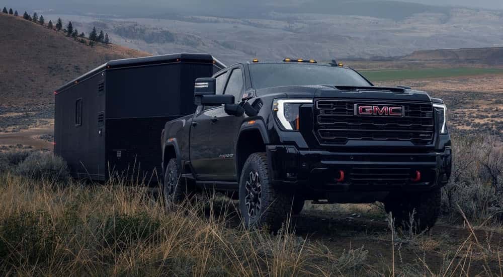 Black 2026 GMC Sierra 3500 HD AT4X towing a trailer