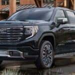 A black 2026 GMC Sierra Denali parked in a driveway.
