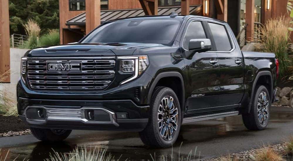 A black 2026 GMC Sierra Denali parked in a driveway.