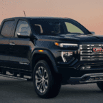 Black 2026 GMC Canyon driving down the road