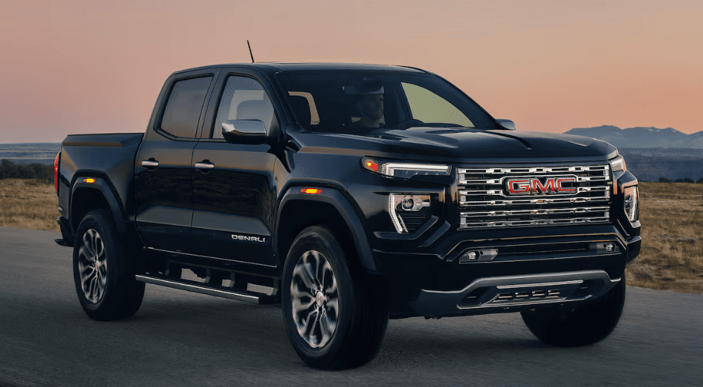 Black 2026 GMC Canyon driving down the road