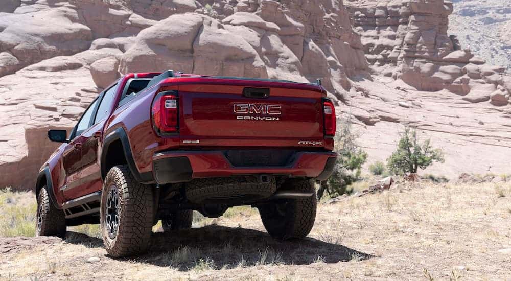 A red 2026 GMC Canyon from the rear.