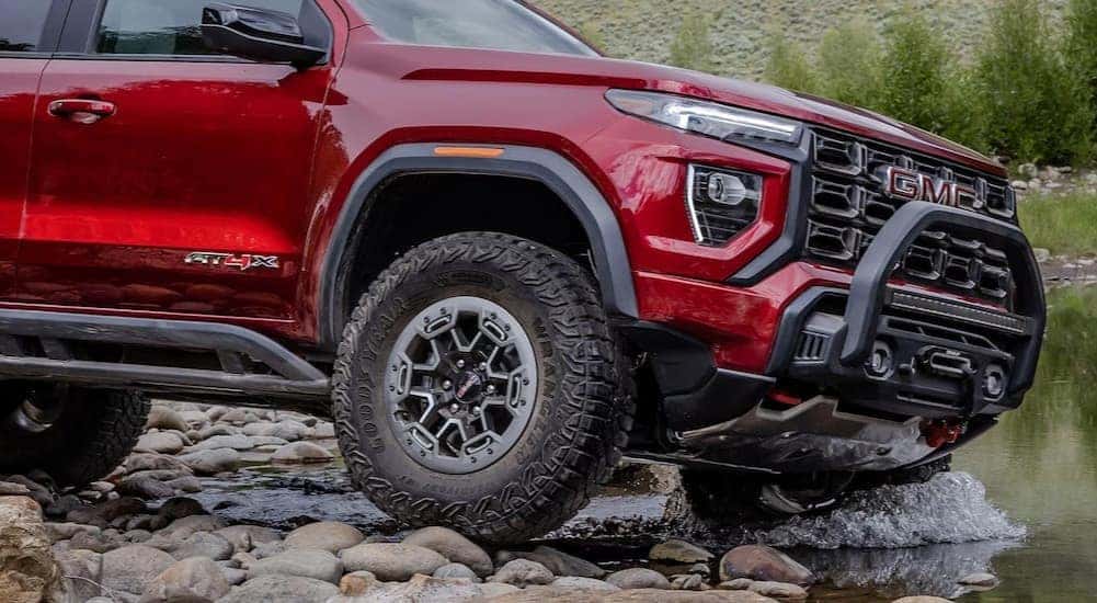 Close-up of the front passenger side of a red 2026 GMC Canyon AT4X.