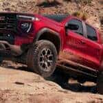 A red 2026 GMC Canyon AT4X off-roading.