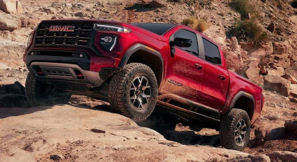 A red 2026 GMC Canyon AT4X off-roading.