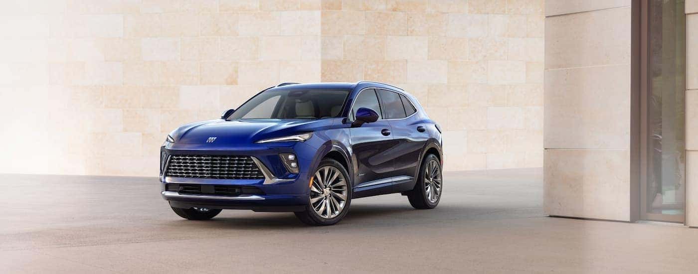 Dark blue 2026 Buick Envision parked near a wall.