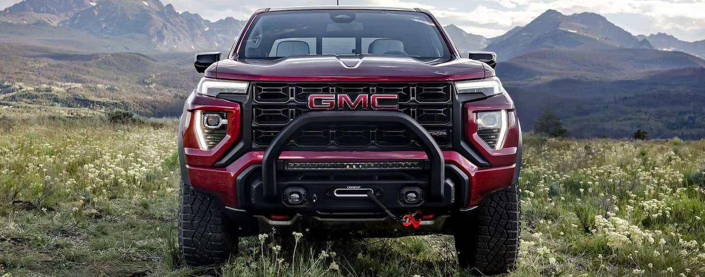 Red 2026 GMC Canyon parked in an open field