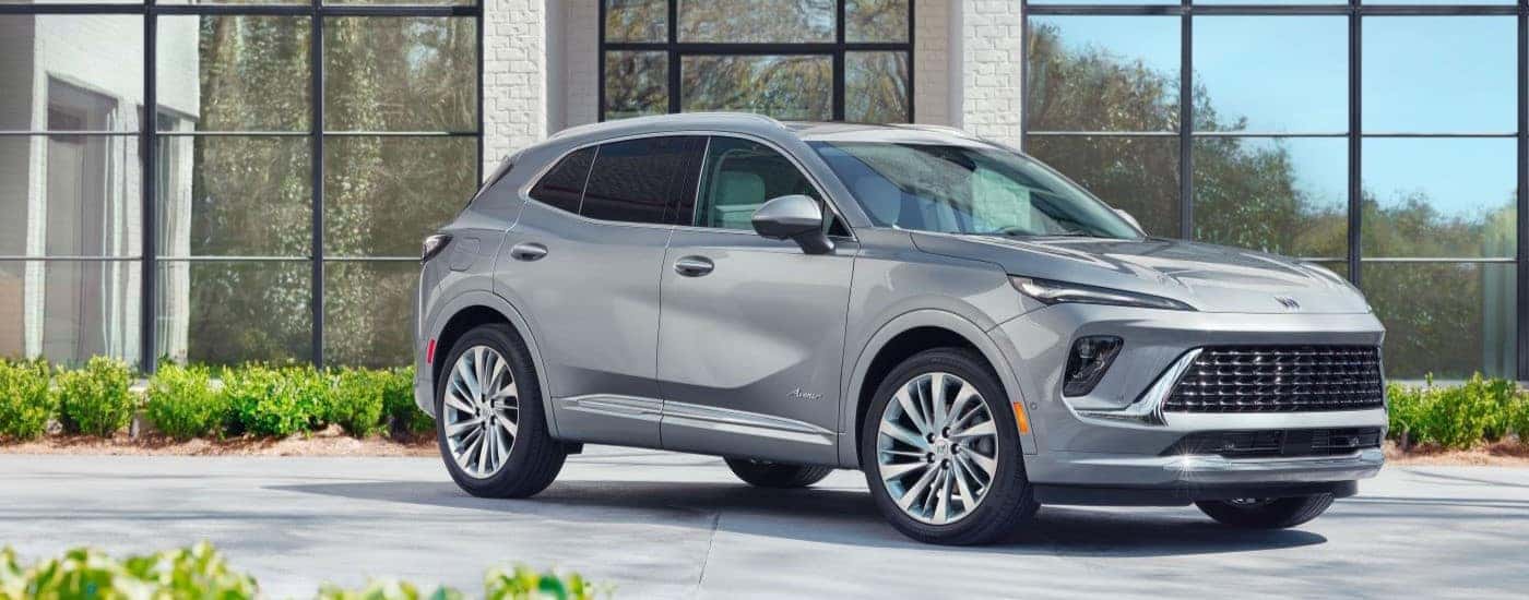 Grey 2024 Buick Envision Avenir parked in a showroom.