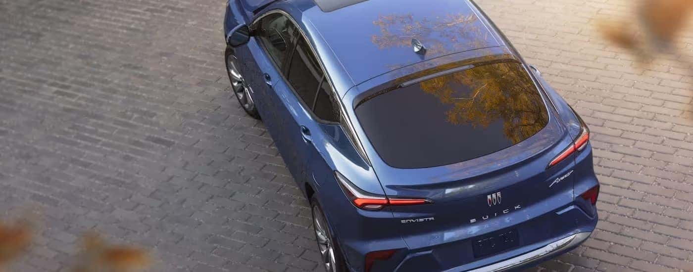 A blue 2024 Buick Envista is shown from above on a brick lot.