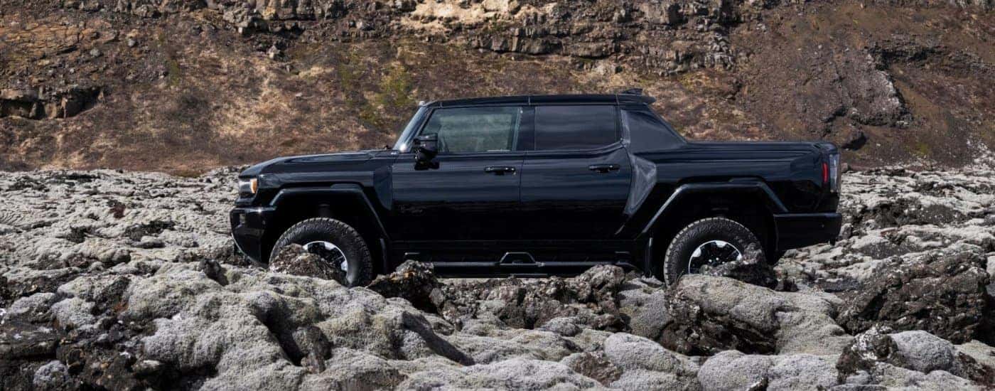 Black 2024 GMC Hummer EV parked off-road