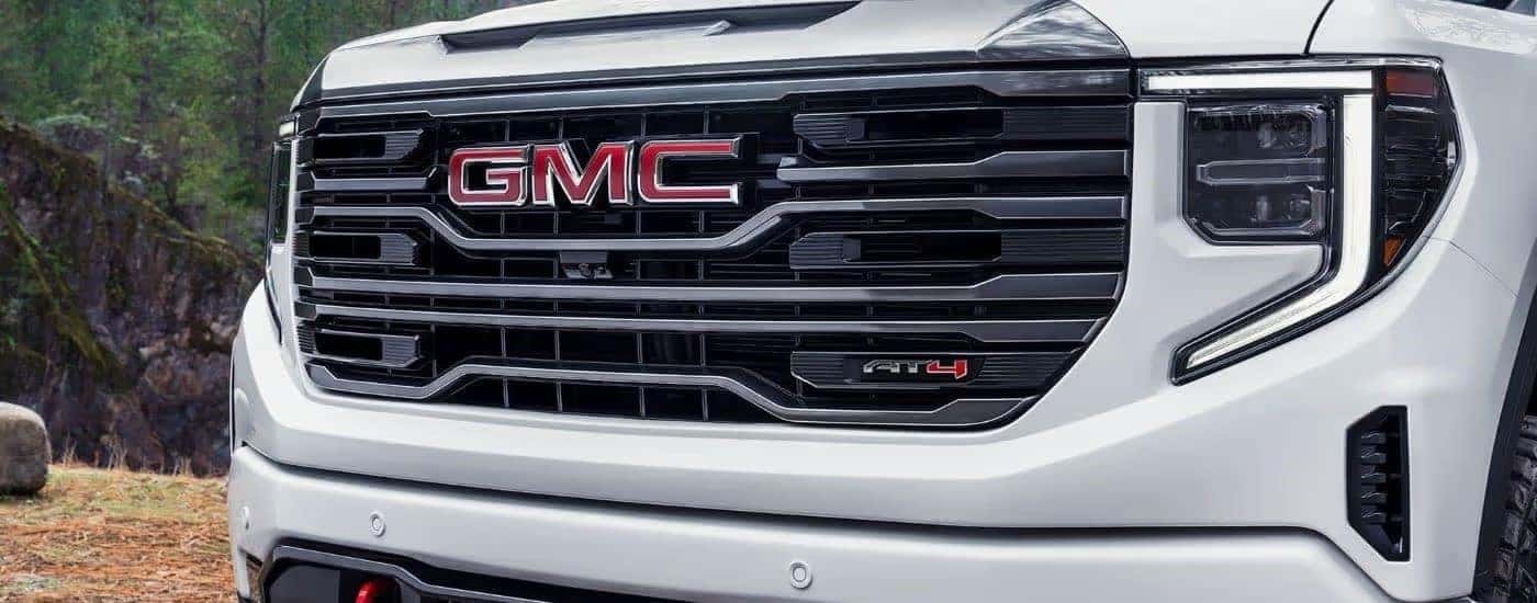 Black grille of a white 2024 GMC Sierra 1500 AT4