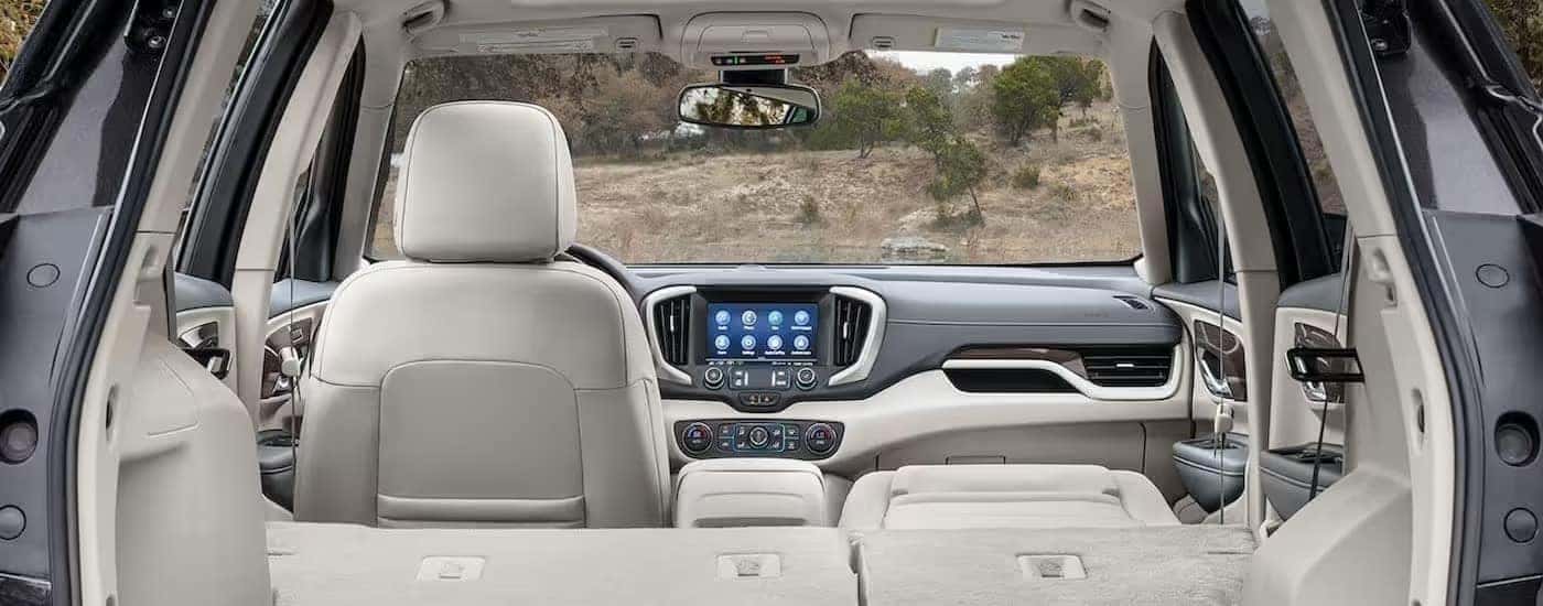 The white and gray interior and dash of a 2024 GMC Terrain is shown.