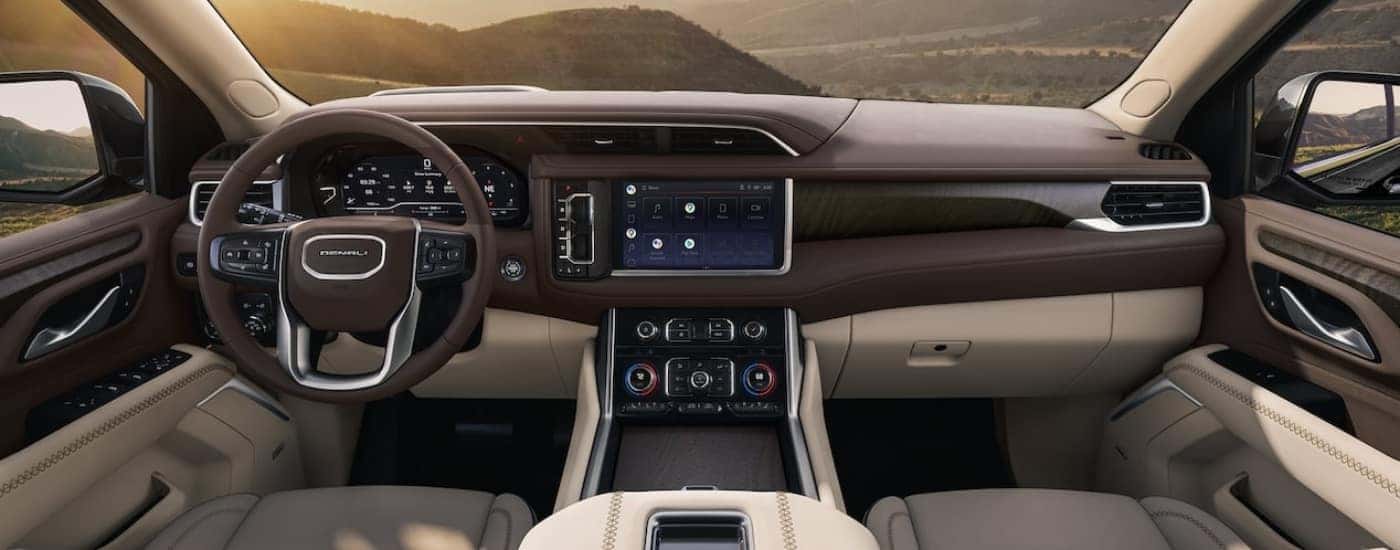 Brown and black interior and dash of a 2024 GMC Yukon Denali