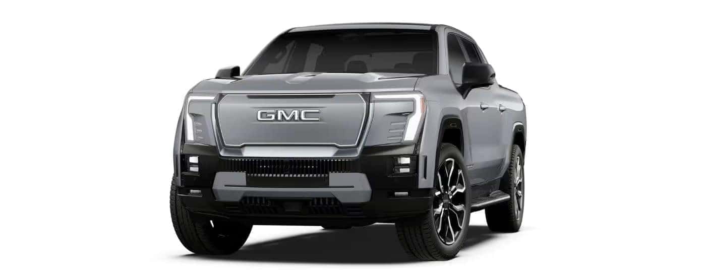 A silver 2025 GMC Sierra EV is facing left.