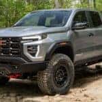 Grey 2026 GMC Canyon AT4X parked on rocks