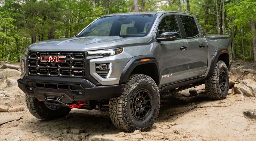 Grey 2026 GMC Canyon AT4X parked on rocks