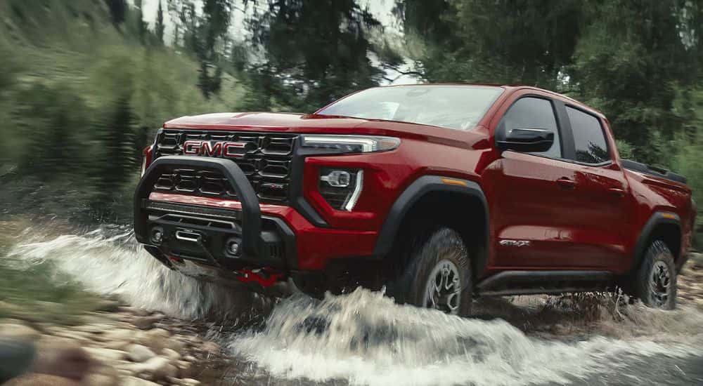 Red GMC Canyon AT4X driving up a river
