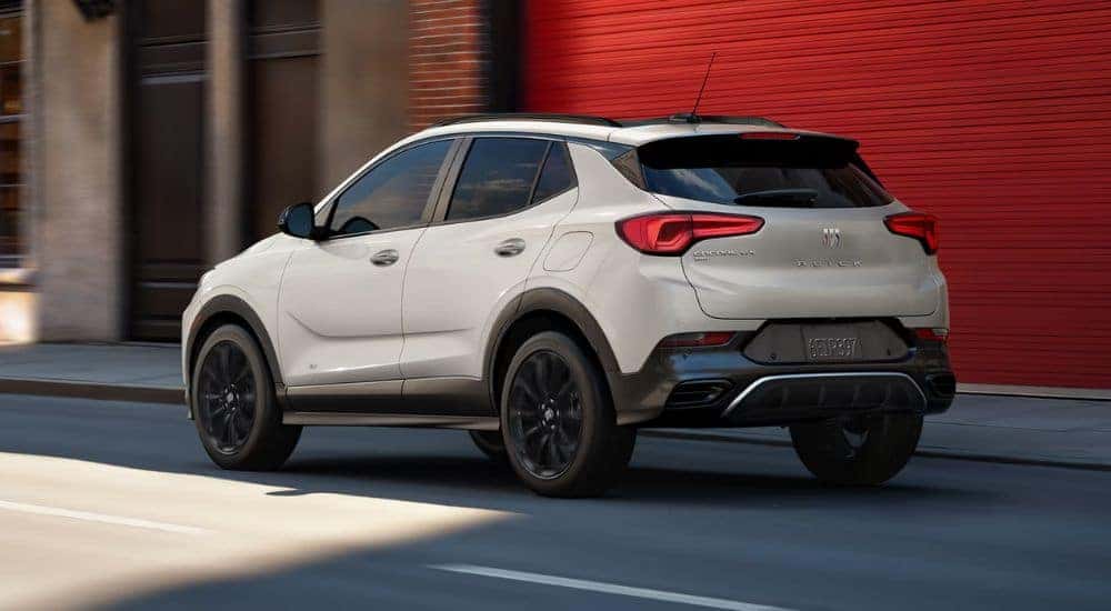 WHite 2026 Buick Encore GX driving down a city street