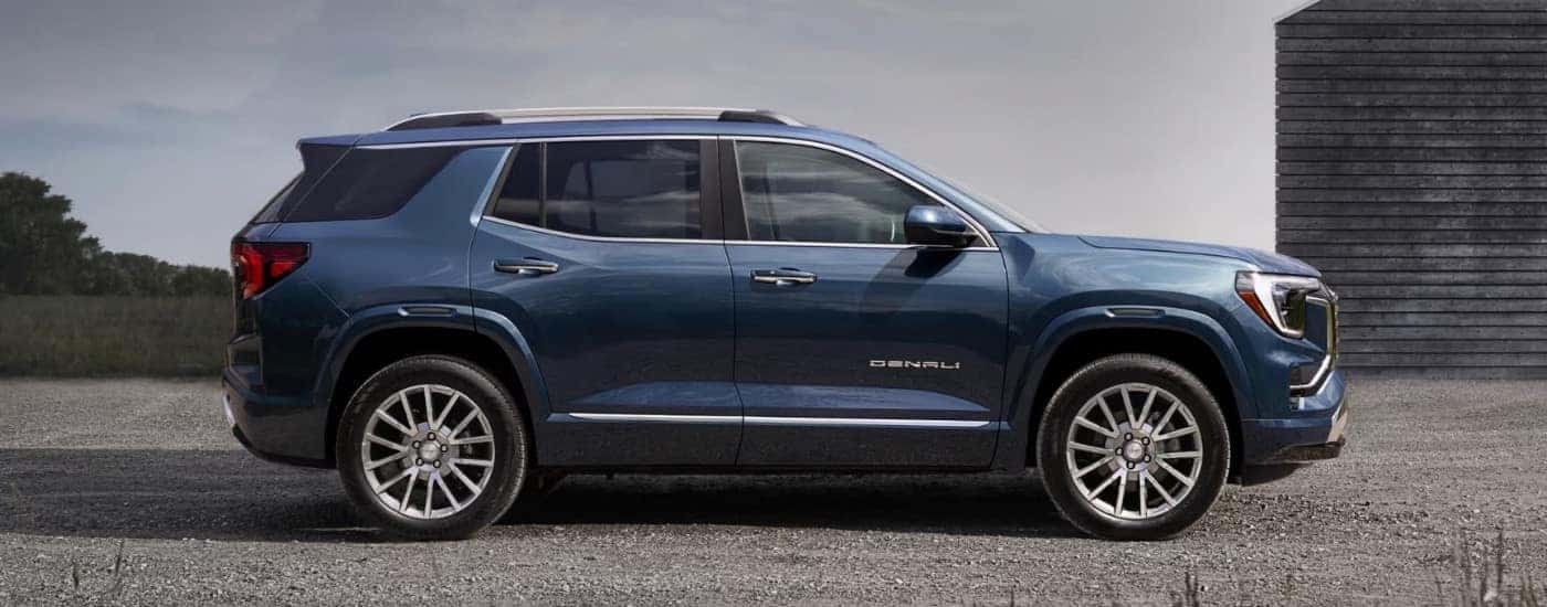 A blue 2026 GMC Terrain Denali shown from side parked.