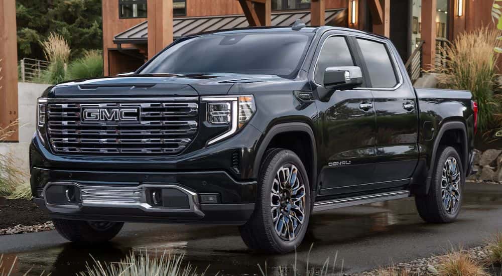 Black 2026 Sierra 1500 Denali parked in a driveway.