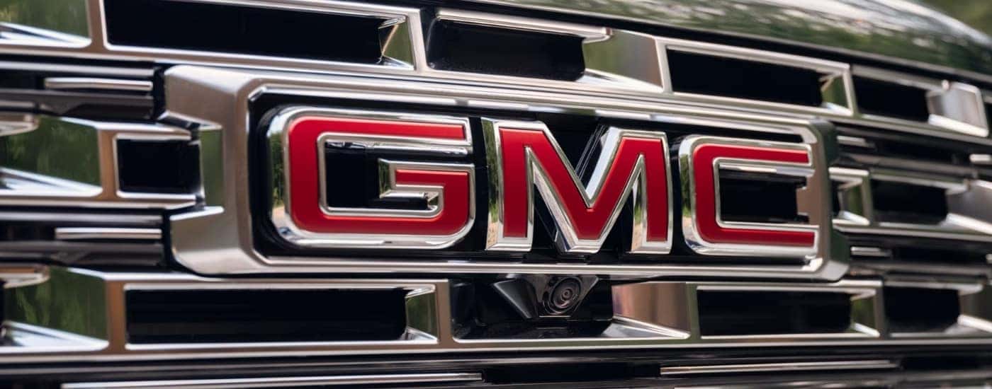 Chrome grille and red GMC logo on a 2026 GMC Acadia Denali
