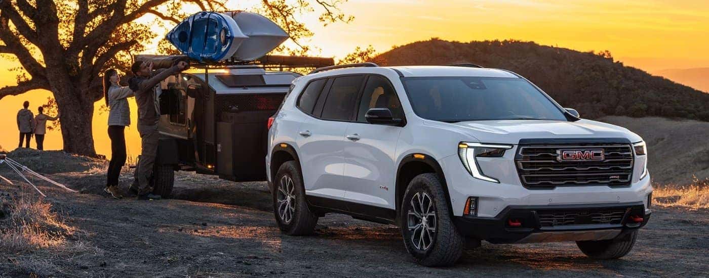 White 2026 GMC Acadia AT4 towing a trailer