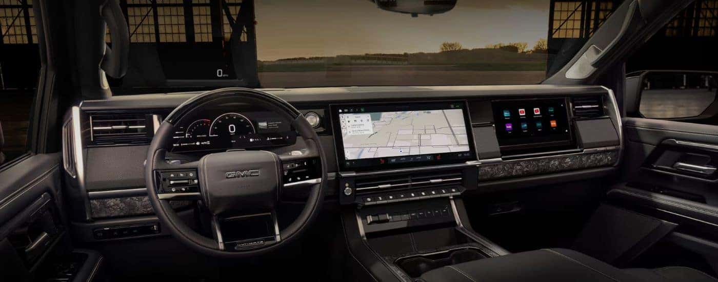 Infotainment display and steering wheel in a 2027 GMC Sierra 1500.