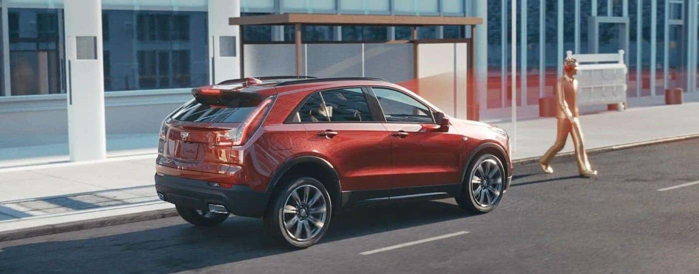 A red 2023 Cadillac XT4 is shown sensing a pedestrian.